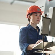 serious-young-asian-operator-in-hardhat-using-computer-of-industrial-machine-while-choosing-setups-in-workshop-1-4-1024x683